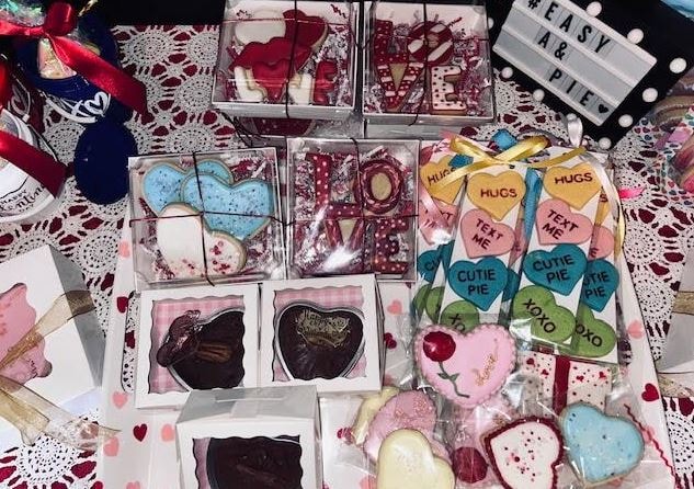 Valentine's Day cookie display with heart cookies, LOVE letters, and conversation hearts