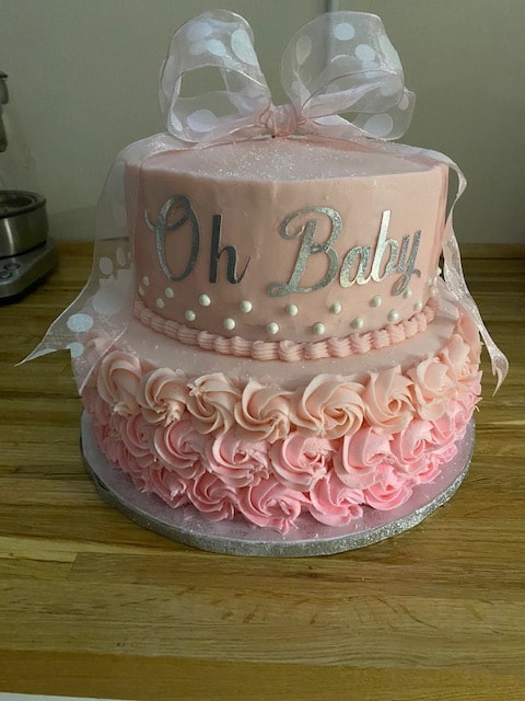 Pink Oh Baby baby shower tiered cake with rosette frosting and polka dot bow