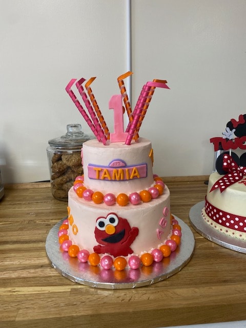 Elmo first birthday cake for Tamia with pink and orange decorations
