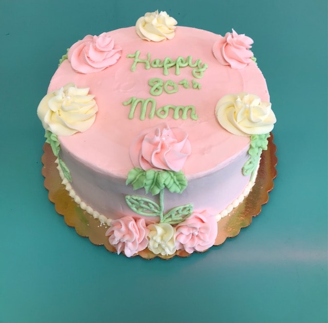 Happy 80th Mom pink birthday cake with floral piping and rose decorations