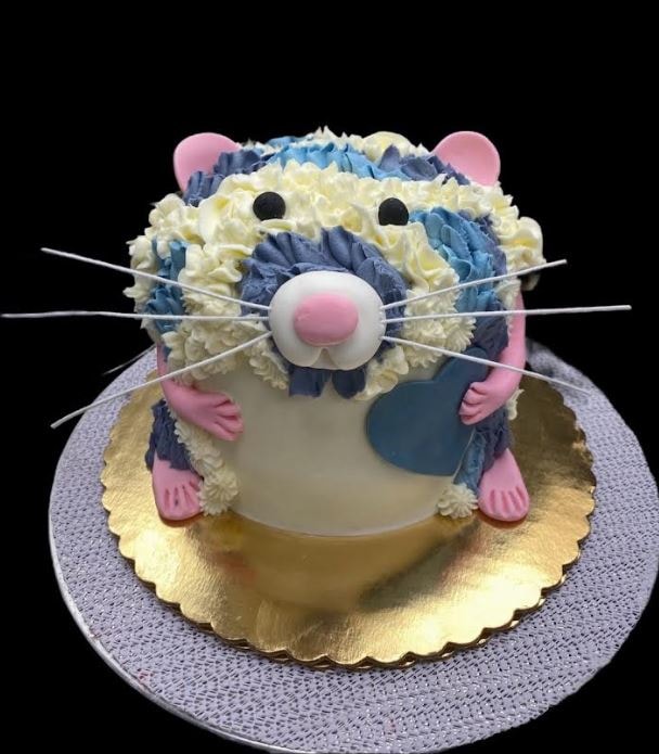 Whimsical rat birthday cake with blue and cream piped fur and pink accents