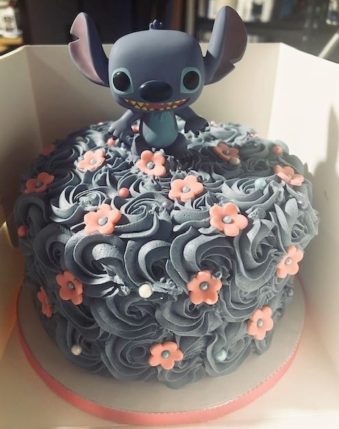 Stitch character birthday cake with pink flowers
