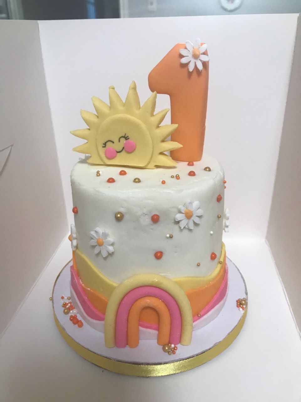 Sunrise smash first birthday cake with rainbow