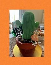 Cactus shaped birthday cake with floral accents