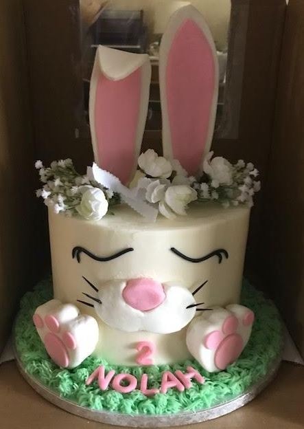 Bunny birthday cake with pink ears and floral topper for Nolan