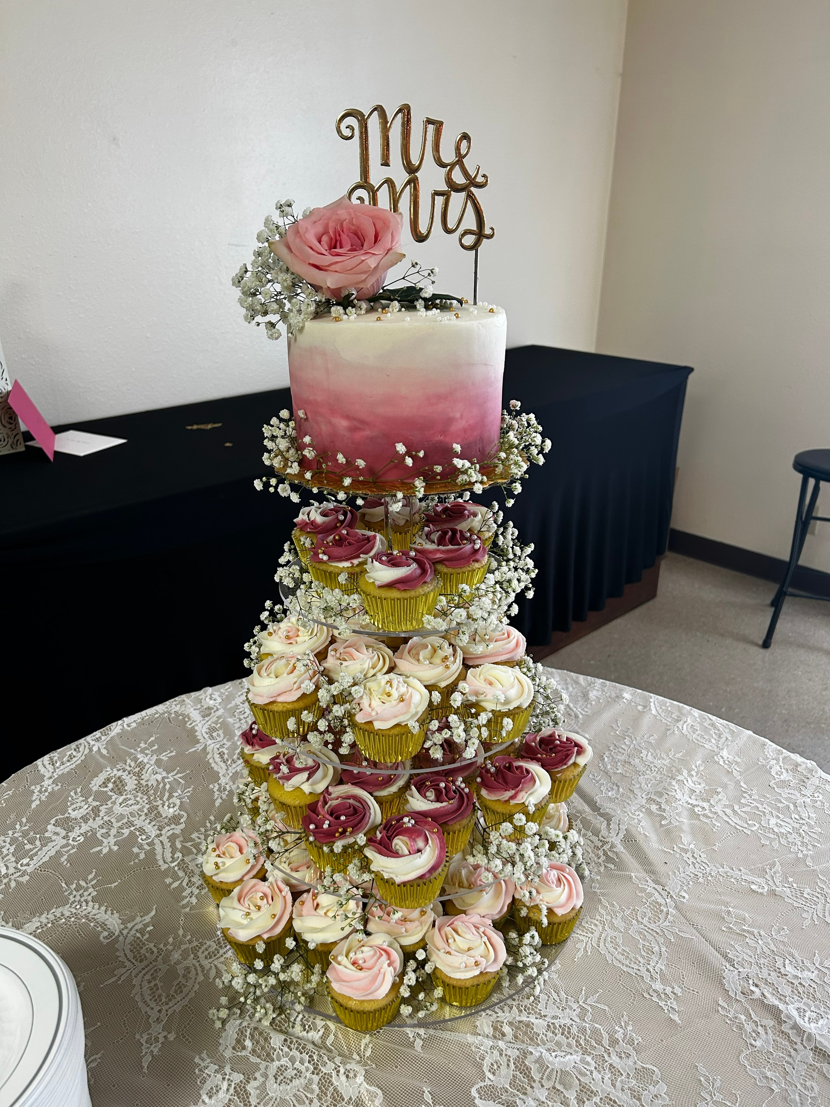Mr and Mrs wedding cake with cupcake tower and pink roses