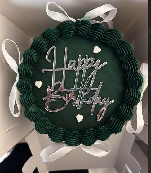 Dark green Happy Birthday cake with white ribbon bows