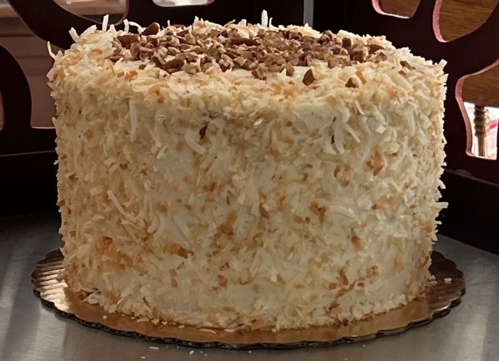 Italian cream cake with toasted coconut and pecan topping