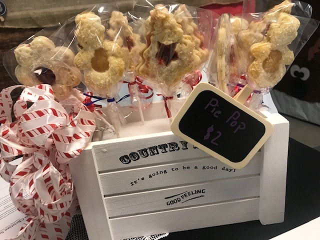 Fall pie pops with plaid ribbons in country crate with sunflowers